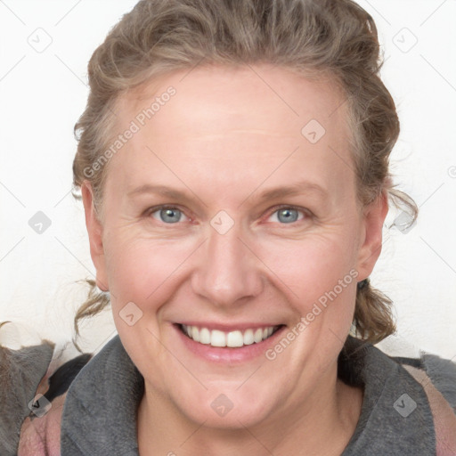 Joyful white adult female with medium  brown hair and blue eyes