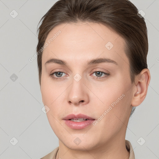 Joyful white young-adult female with short  brown hair and grey eyes