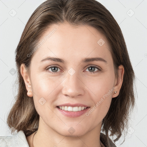 Joyful white young-adult female with medium  brown hair and grey eyes