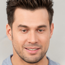 Joyful white young-adult male with short  brown hair and brown eyes