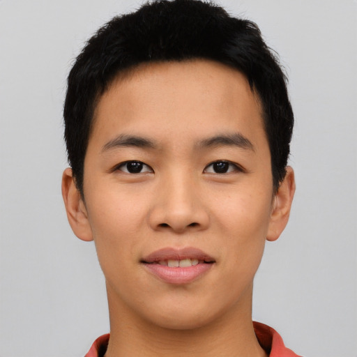 Joyful asian young-adult male with short  black hair and brown eyes