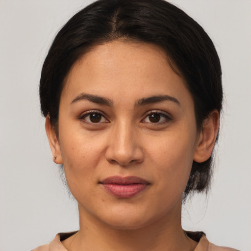 Joyful latino young-adult female with medium  brown hair and brown eyes
