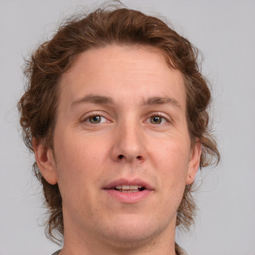 Joyful white adult male with medium  brown hair and grey eyes