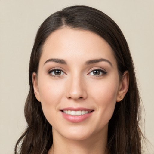 Joyful white young-adult female with long  brown hair and brown eyes