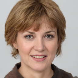 Joyful white adult female with medium  brown hair and grey eyes