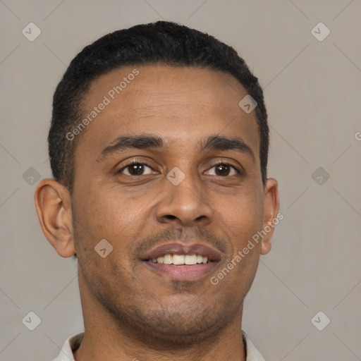 Joyful black young-adult male with short  brown hair and brown eyes