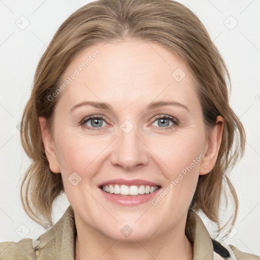 Joyful white adult female with medium  brown hair and blue eyes