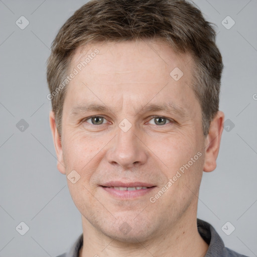 Joyful white adult male with short  brown hair and grey eyes