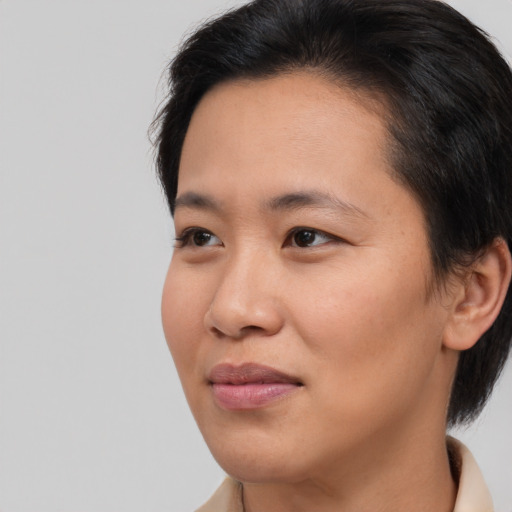Joyful asian young-adult female with medium  brown hair and brown eyes