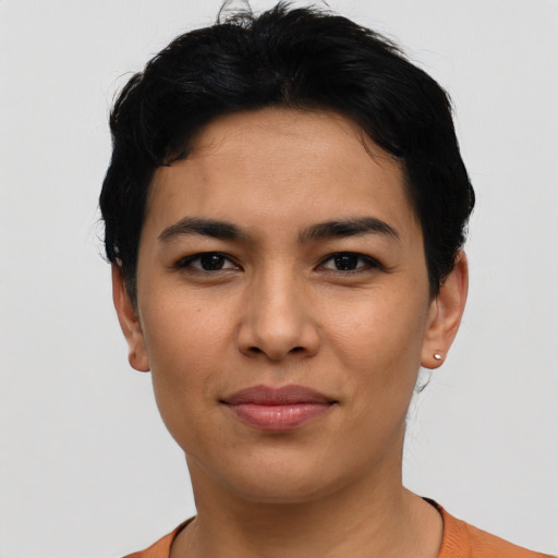 Joyful latino young-adult female with short  black hair and brown eyes