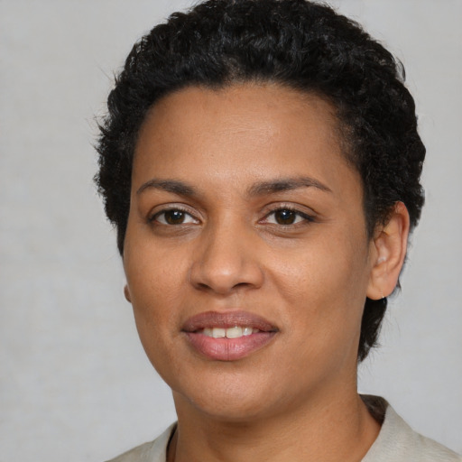 Joyful latino young-adult female with short  black hair and brown eyes