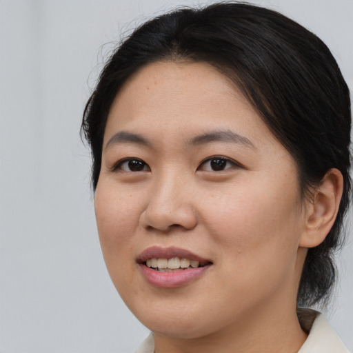 Joyful asian young-adult female with medium  brown hair and brown eyes