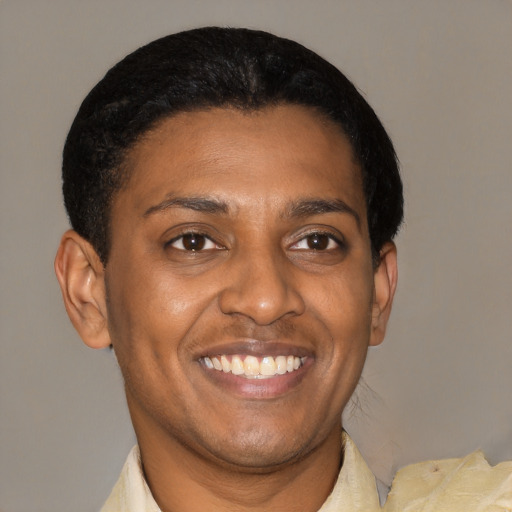 Joyful latino young-adult male with short  brown hair and brown eyes