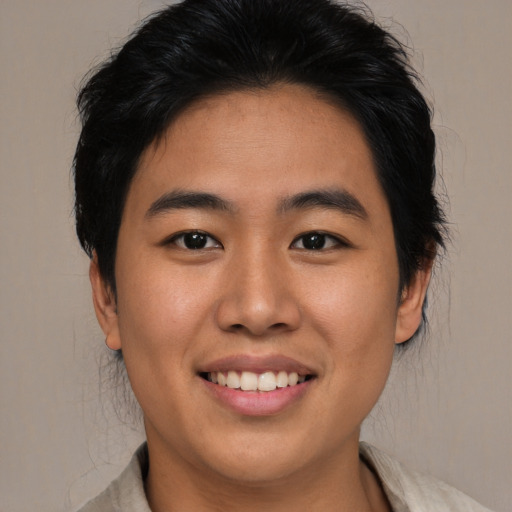 Joyful asian young-adult male with medium  brown hair and brown eyes
