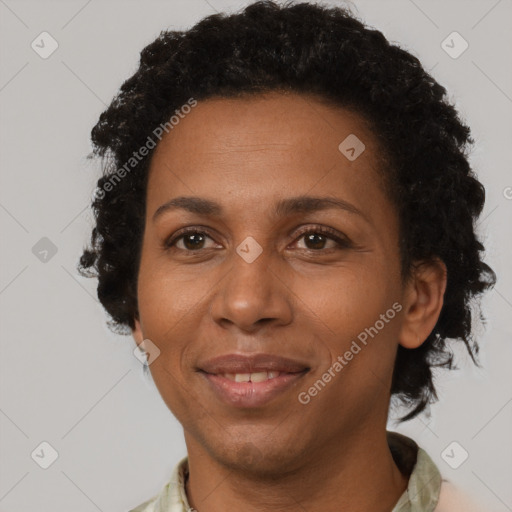 Joyful black adult female with short  brown hair and brown eyes