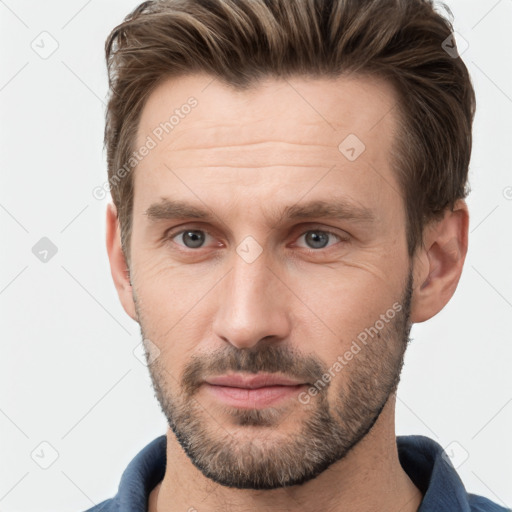 Joyful white adult male with short  brown hair and grey eyes