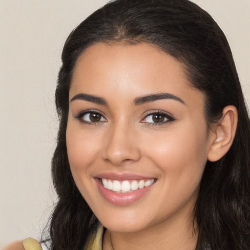 Joyful latino young-adult female with long  brown hair and brown eyes