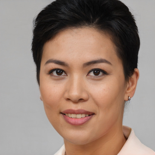 Joyful asian young-adult female with short  brown hair and brown eyes