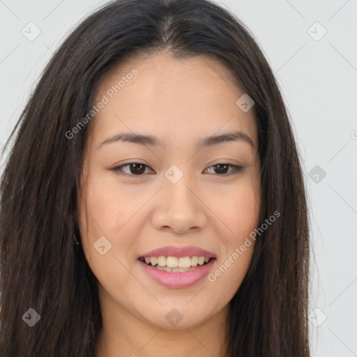 Joyful asian young-adult female with long  brown hair and brown eyes