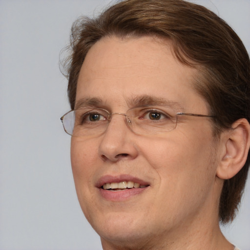 Joyful white adult male with medium  brown hair and brown eyes