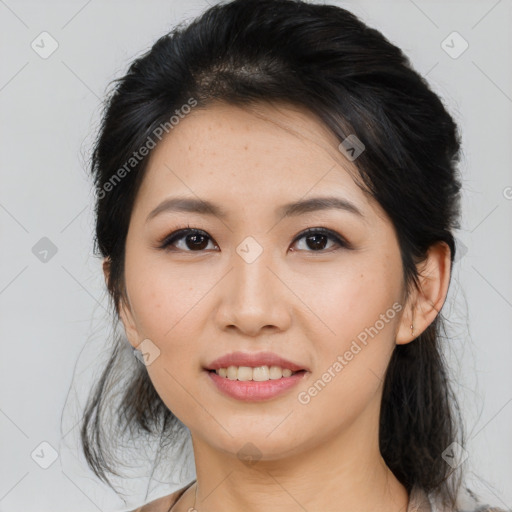 Joyful asian young-adult female with medium  black hair and brown eyes