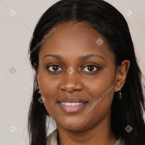 Joyful black young-adult female with long  black hair and brown eyes