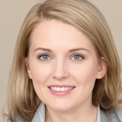 Joyful white young-adult female with medium  brown hair and blue eyes