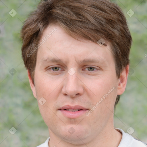 Joyful white adult male with short  brown hair and grey eyes