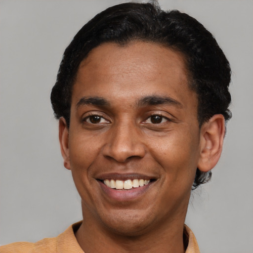 Joyful latino young-adult male with short  black hair and brown eyes