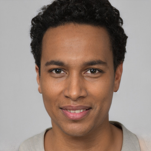 Joyful black young-adult male with short  black hair and brown eyes