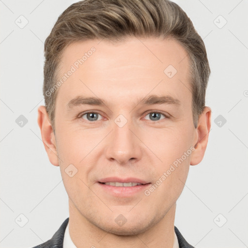 Joyful white young-adult male with short  brown hair and grey eyes