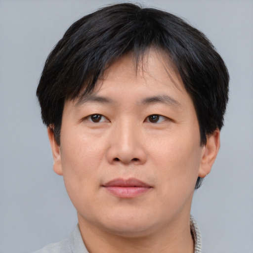 Neutral asian adult male with short  brown hair and brown eyes