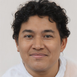Joyful latino young-adult male with short  brown hair and brown eyes