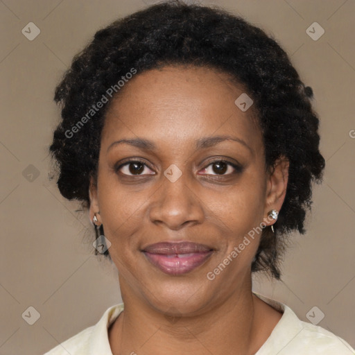 Joyful black adult female with medium  brown hair and brown eyes