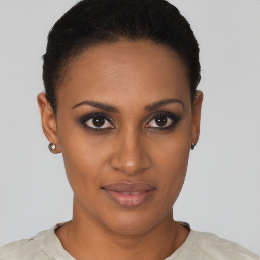 Joyful black young-adult female with short  brown hair and brown eyes