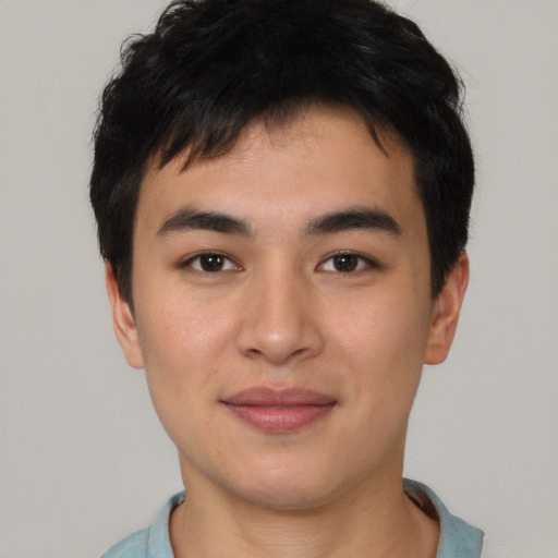 Joyful asian young-adult male with short  black hair and brown eyes