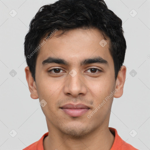 Joyful white young-adult male with short  black hair and brown eyes