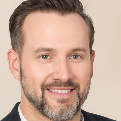 Joyful white adult male with short  brown hair and brown eyes