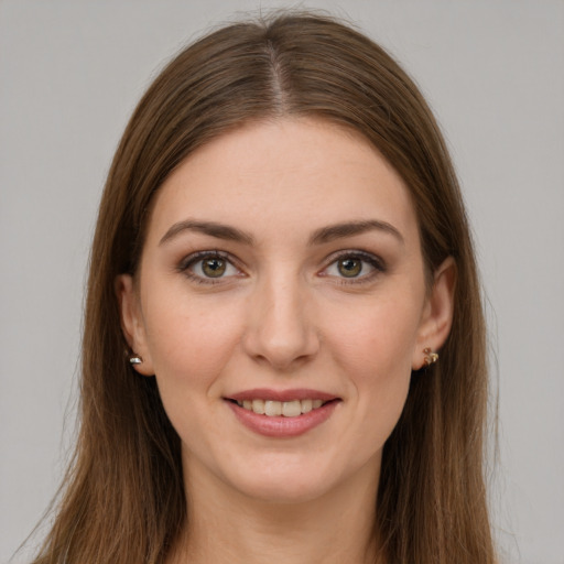 Joyful white young-adult female with long  brown hair and green eyes