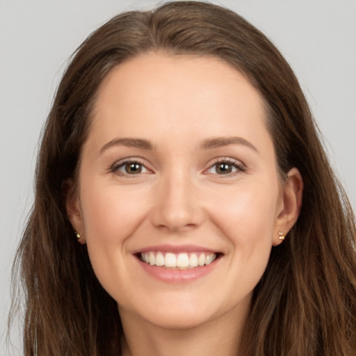 Joyful white young-adult female with long  brown hair and brown eyes