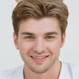 Joyful white young-adult male with short  brown hair and blue eyes