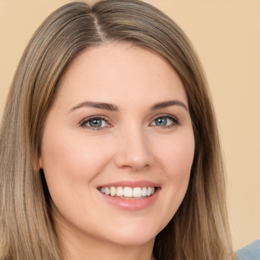 Joyful white young-adult female with long  brown hair and brown eyes