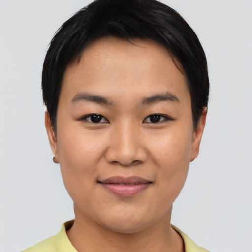Joyful asian young-adult female with short  black hair and brown eyes