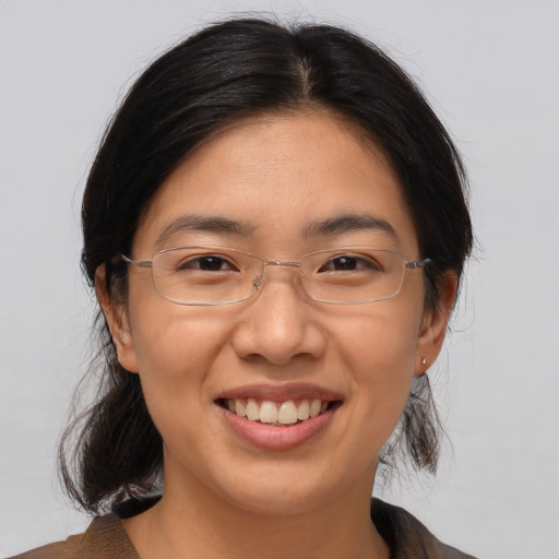 Joyful asian adult female with medium  brown hair and brown eyes