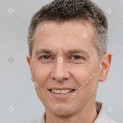 Joyful white adult male with short  brown hair and brown eyes