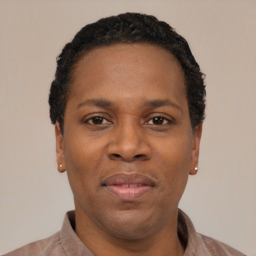 Joyful black young-adult female with short  black hair and brown eyes