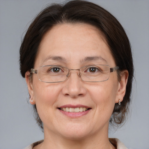 Joyful white adult female with medium  brown hair and brown eyes