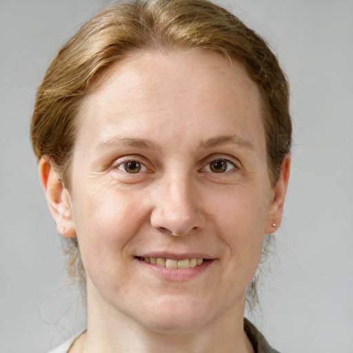 Joyful white adult female with medium  brown hair and grey eyes