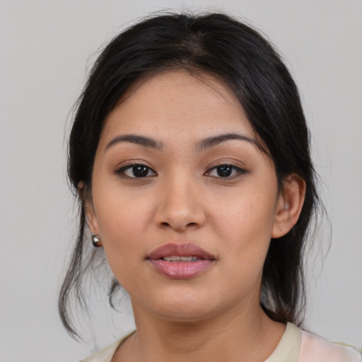 Joyful asian young-adult female with medium  black hair and brown eyes