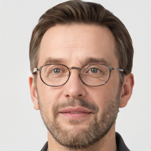 Joyful white adult male with short  brown hair and grey eyes